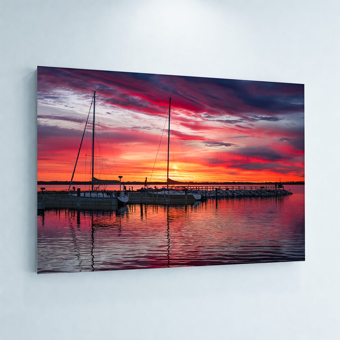 Metal print of Northport Marina on Grand Traverse Bay with sailboats at sunrise under a vibrant red, orange and blue sky.