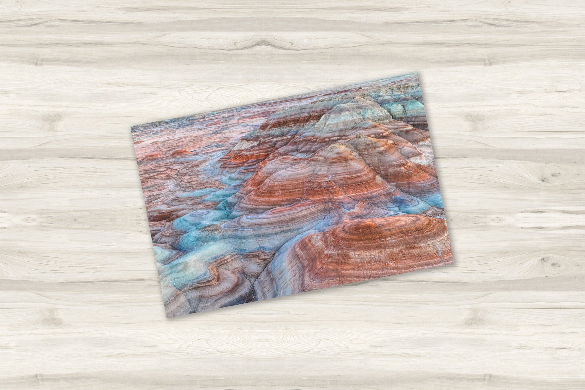 Fine art print of Bentonite Hills Utah on light wooden table top