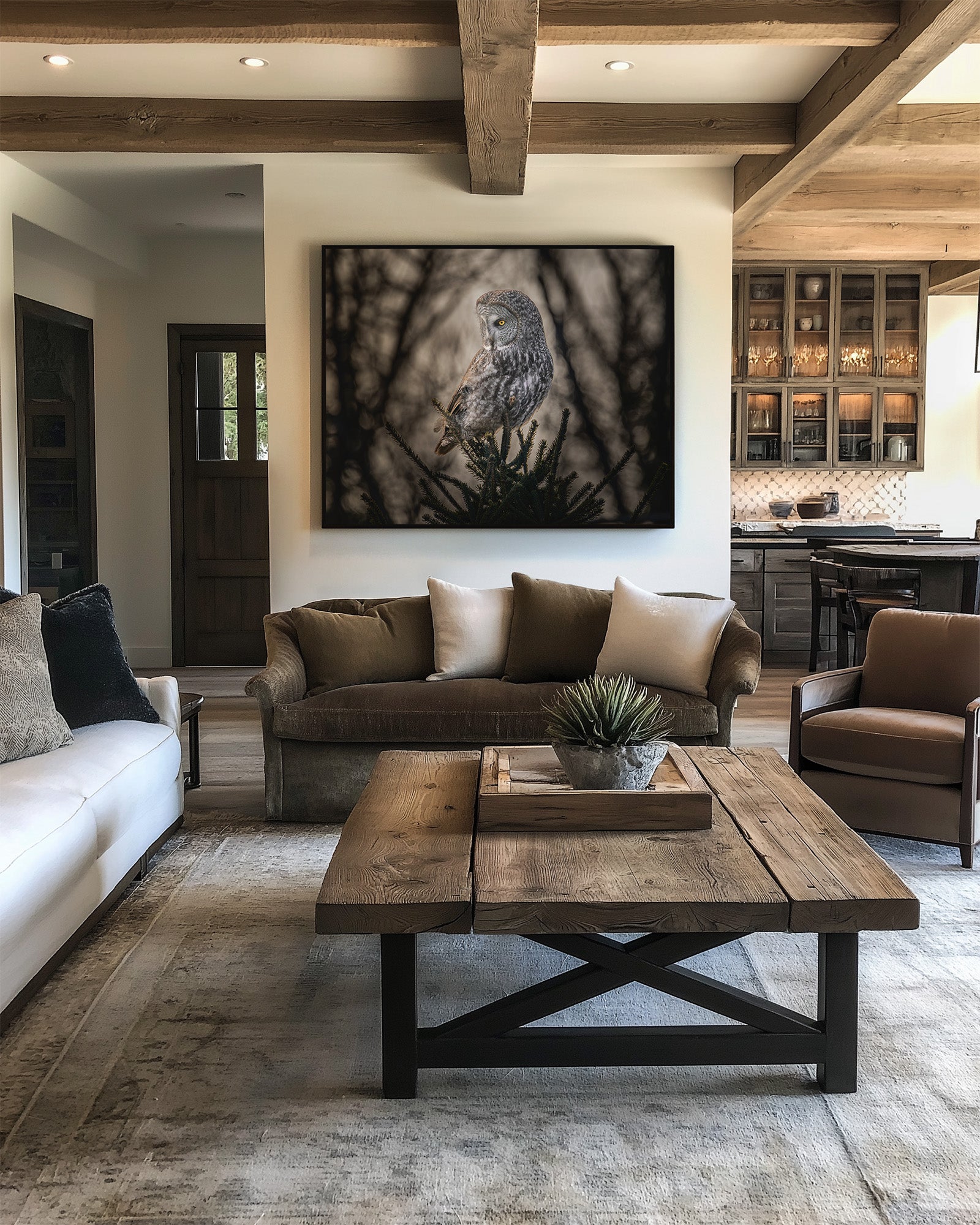 Modern living room with Great Gray Owl print over brown sofa, cream rug, and wooden coffee table.