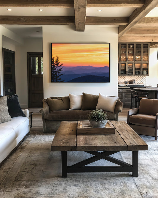 Modern living room with brown sectional sofa, white armchair, wooden coffee table, and smoky mountain sunset painting.