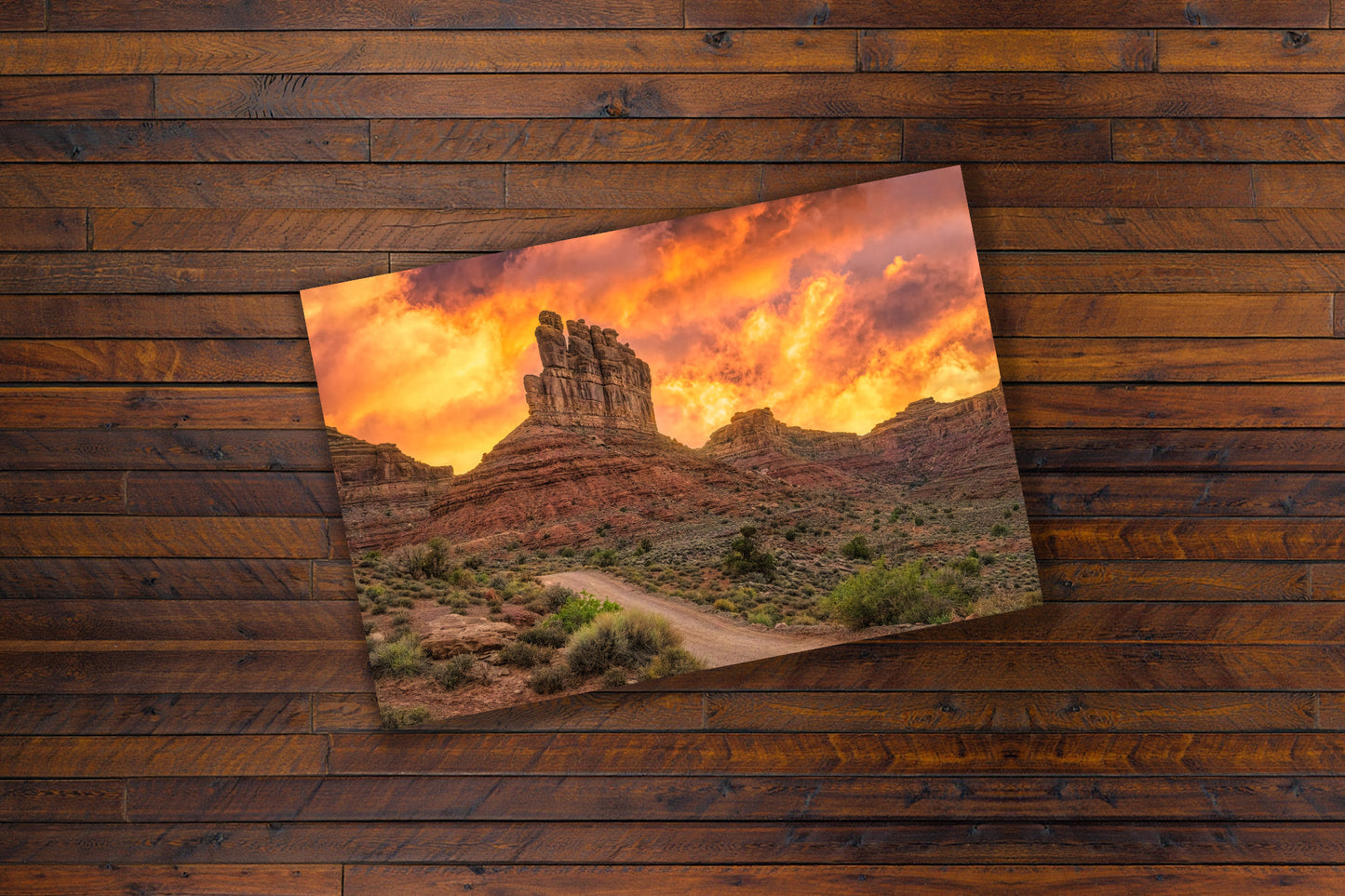 Scenic landscape print of a Utah desert with rocky formations and sunset sky on a wooden surface.